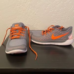 Gray and orange Nike free running shoes